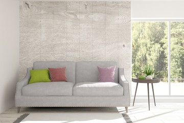 White room with sofa and green landscape in window. Scandinavian interior design. 3D illustration