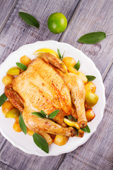 Chicken with Lemon, Lime and Potato Garnished with Sage. View from above, top studio shot