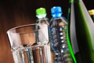 Composition with glass and bottles of mineral water
