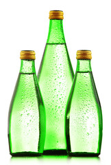 Glass bottles of mineral water isolated on white