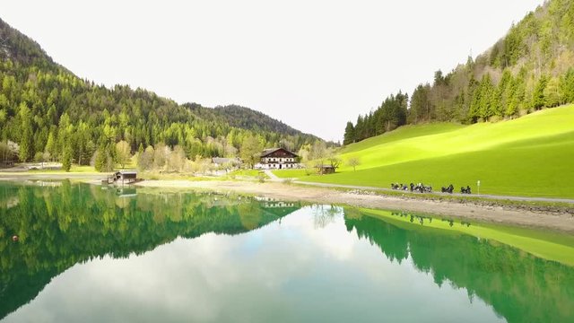 Aerial: flying over Hintersteiner Mountain lake with clear water in Austria