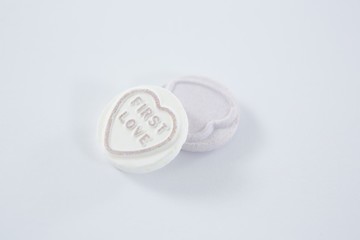 Heart shape confectionery with text first love
