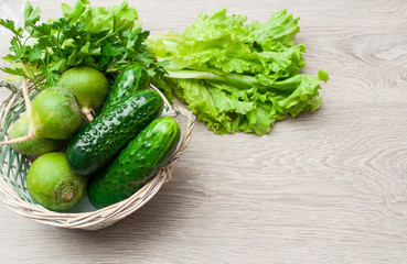 Green vegetables in a wicker basket. The concept of a healthy diet