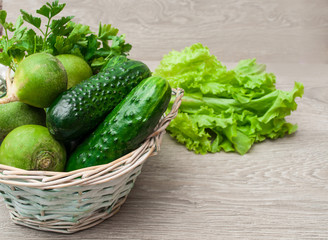 Green vegetables in a wicker basket. The concept of a healthy diet