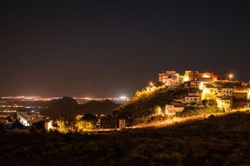 Beautiful Night Shot of Illuminated Spanish Village on a Hill with Meadow, Landscape View and Stars, Tenerife, Canary Islands