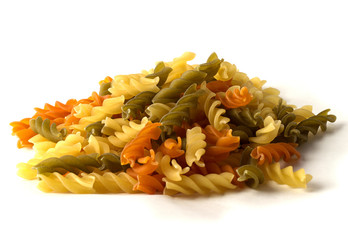 Uncooked pasta fusilli in different colours, white background