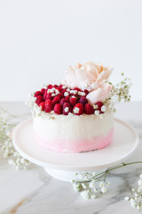 Sweet white cream mousse cake with raspberries on light background. (no baked cheesecake). Wedding cake