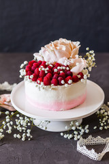 Sweet white cream mousse cake with raspberries on light background. (no baked cheesecake). Wedding cake