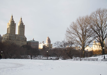 Fototapeta na wymiar Snow at Central Park and buildings in Manhattan