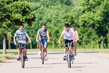 Family of four on bike tour in summer