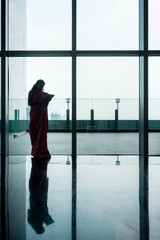 Fototapeta na wymiar Indian woman using tablet on corridor of modern corporate building