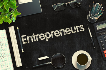 Entrepreneurs. Business Concept Handwritten on Black Chalkboard. Top View Composition with Chalkboard and Office Supplies. 3d Rendering. Toned Image.