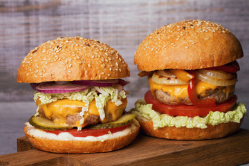 Beef burgers with red and yellow peppers, napa cabbage, tomato and cheddar