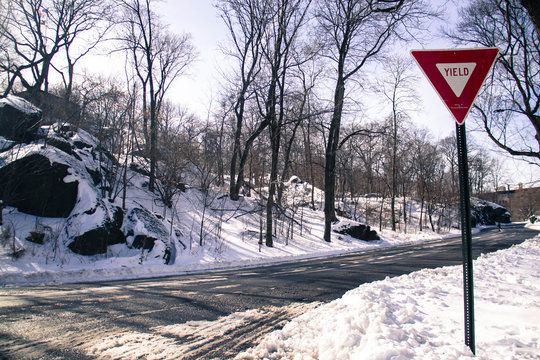 Road and traffic sign on snow at park in old picture style