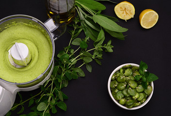 Bean paste and boiled broad beans on a black background.