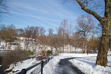 Road, lake and snow in winter with blue sky