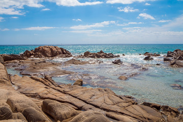 Rocks in crystal clear sea water of Villasimius beach, Sardinia island, Italy