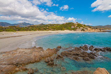 Rocks in crystal clear sea water of Villasimius beach, Sardinia island, Italy