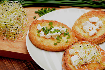 French toasts with goats cheese, fresh chives and sprouts.
