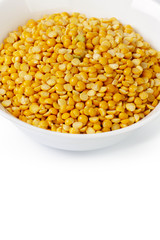 Dry yellow split peas isolated on white.