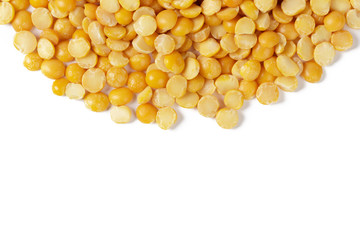 Dry yellow split peas isolated on white.