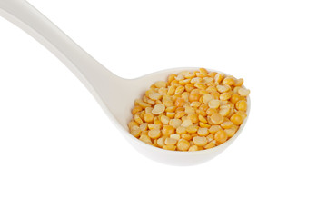 Dry yellow split peas isolated on white.