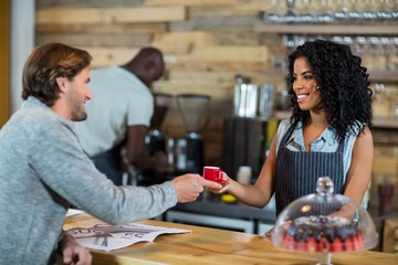Waitress serving a cup of coffee at counter