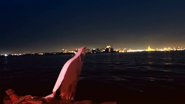 View from front of dhow boat crossing Doha West Bay at night