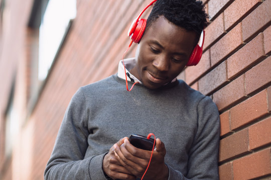 African american man listen music in city