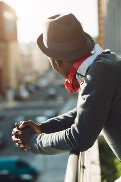 African american man with headphones looking at city
