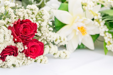 White flowers with red roses decors on white table