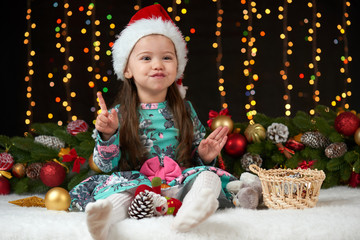 child girl portrait in christmas decoration, happy emotions, winter holiday concept, dark background with illumination and boke lights