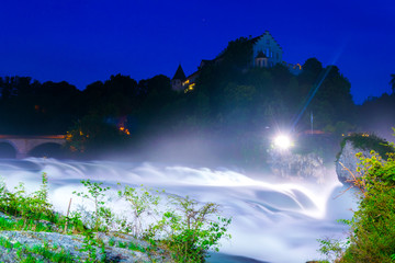 Naklejka na ściany i meble View of the europen biggest waterfall - rheinfall - during night near Schaffhausen, Switzerland