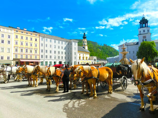 Naklejka na ściany i meble Central place in Salzburg city with carriages and horses