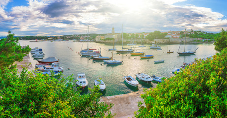 Obraz na płótnie Canvas Wonderful romantic summer evening landscape panorama coastline Adriatic sea. Boats and yachts in harbor at cristal clear azure water. Old town of Krk on the island of Krk. Croatia. Europe.