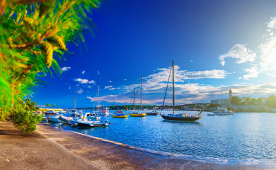 Wonderful romantic summer evening landscape panorama coastline Adriatic sea. Boats and yachts in harbor at cristal clear azure water. Old town of Krk on the island of Krk. Croatia. Europe.