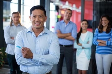 Portrait of businesspeople standing with arms crossed