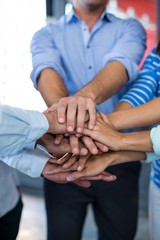 Team of businesspeople forming handstack