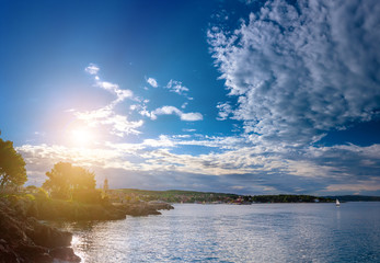 Wonderful romantic summer evening landscape panorama coastline Adriatic sea. Boats and yachts in harbor at cristal clear azure water. Old town of Krk on the island of Krk. Croatia. Europe.