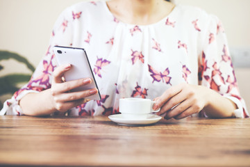 woman hand phone with cup of coffee
