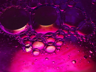 Fototapeta na wymiar Purple oil on water macro background.
