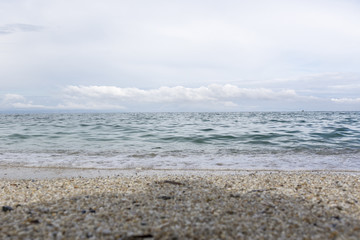 Landscape with sea view, waves, rocks and sea shells, clouds, photographed in Greece