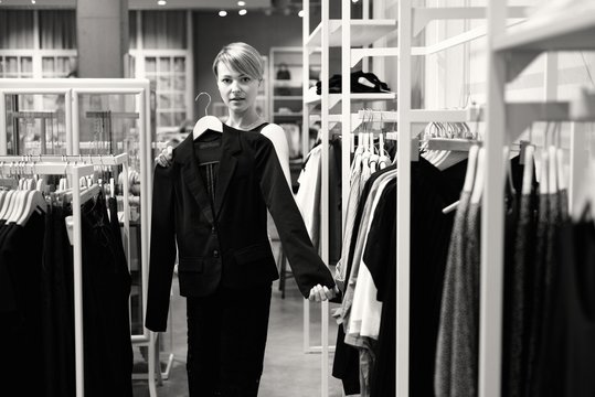 Junge Frau beim Shopping in einem Modehaus mit einem Jacket