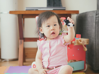 baby girl playing puppet at home