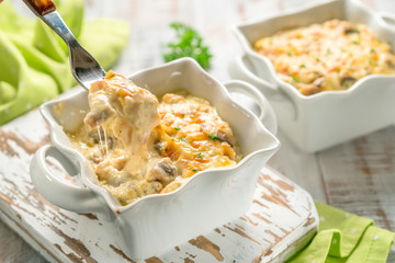 Baked gratin casserole chicken with mushrooms with cheese