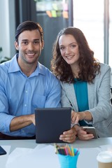 Fototapeta na wymiar Male and female business executive using digital tablet