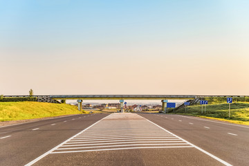Multi-lane countryside asphalt road with marking. Intersection of the country roads on two levels. Disappearing into the distance perspective. Belgorod region, Russia. - obrazy, fototapety, plakaty
