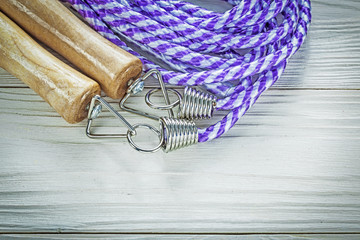 Rolled jump rope on wooden board sports training concept