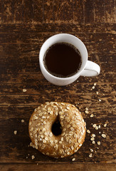 Oat Bagel and Coffee on a wooden table with copy space