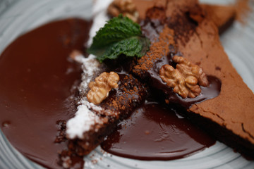 Brownie cake with walnut and chocolate on the plate